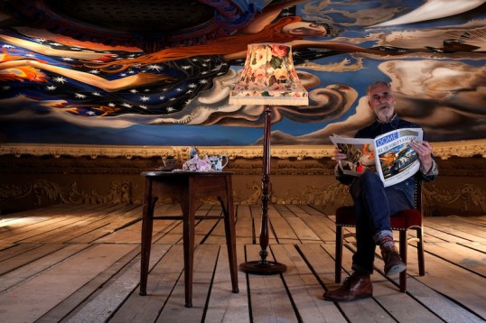 Portrait of John Byrne ‘at home’ with the completed dome painting. Ron created a ‘living room’ setting with table, tea service, standard lamp and John reading a copy of the Metro, photoshopped and retitled ‘DOME’. The only thing missing? An ashtray – John couldn’t smoke on site at the King’s.