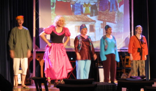 The 2009 production of Aladdin with John Webster (second left) as Widow Twankey in the dress once worn by Stanley Baxter.
