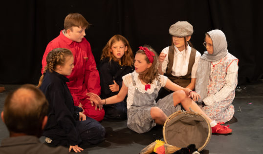Robin Hill as Dorothy with members of the cast in Tribe Porty Youth Theatre's EdFringe 2018 production of The Wizard of Oz.