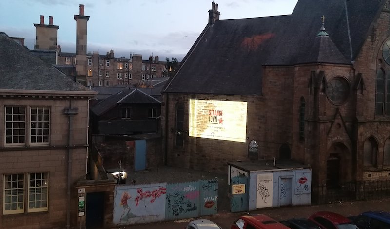 The filmed section was screened against the side of the church next door to Out Of The Blue